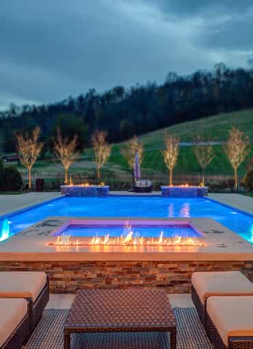 Formal pool with fire features, night lighting and fountains